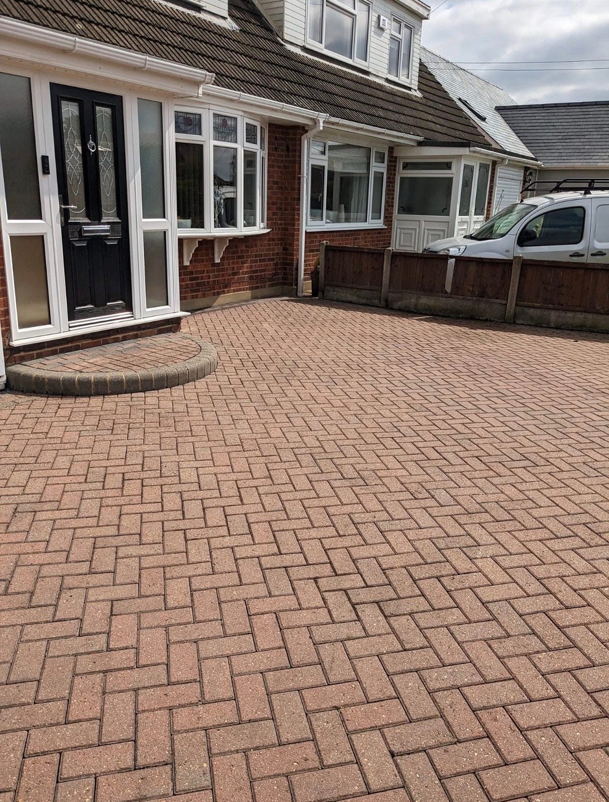 Red brick herringbone paved driveway after professional pressure washing